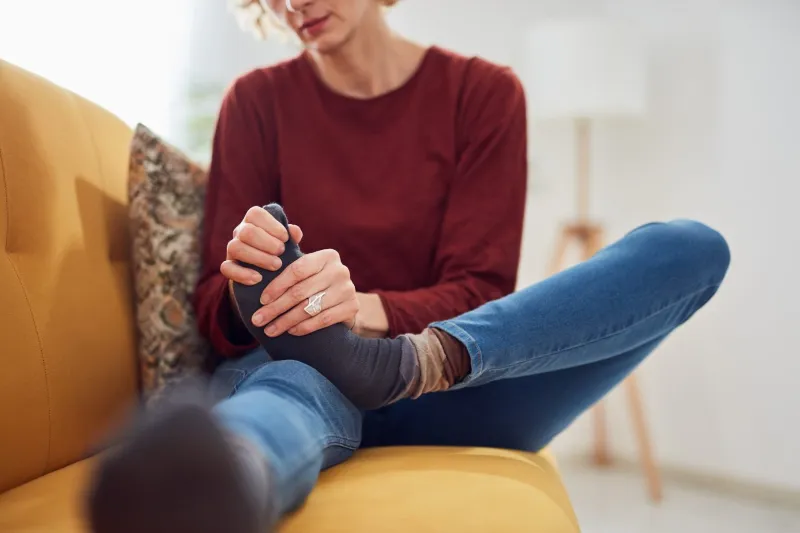 Corn treatment woman touching foot 1536x1024 1